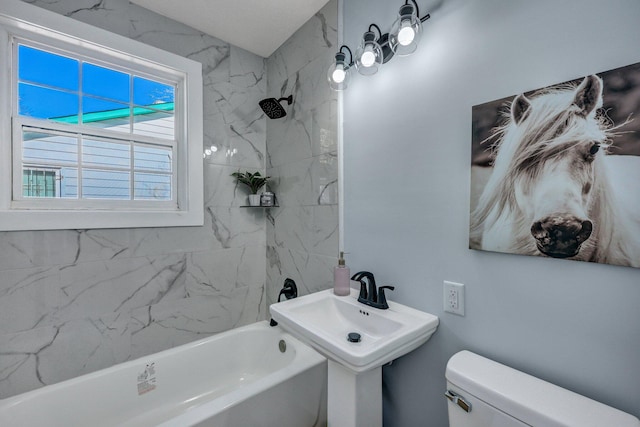 full bathroom with tiled shower / bath, toilet, and sink