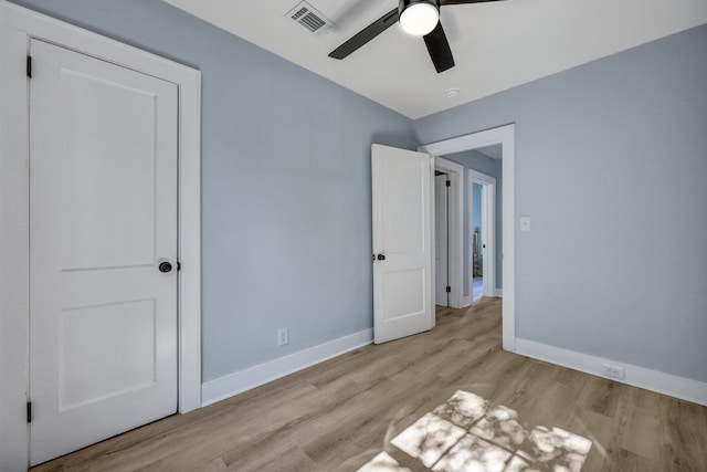 unfurnished bedroom with ceiling fan and light wood-type flooring