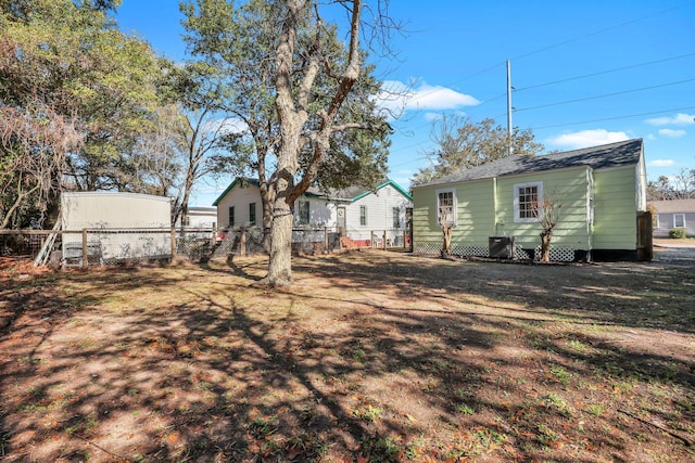 rear view of property with a yard