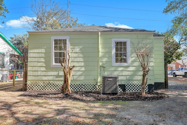 view of side of home with central AC