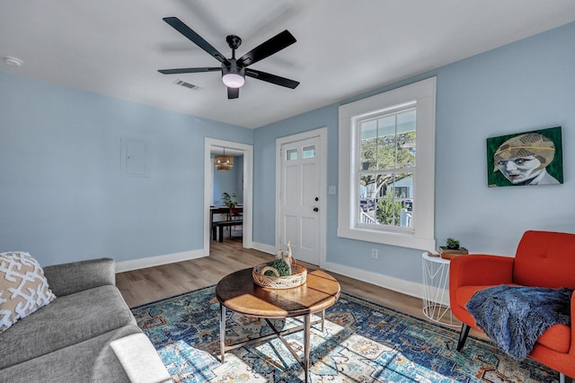 living room with wood-type flooring and ceiling fan