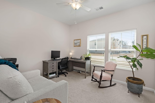 office area featuring a ceiling fan, visible vents, carpet floors, and baseboards