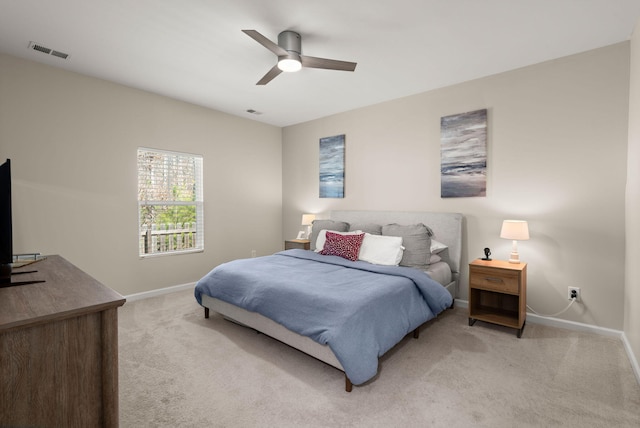 bedroom with visible vents, baseboards, and light colored carpet