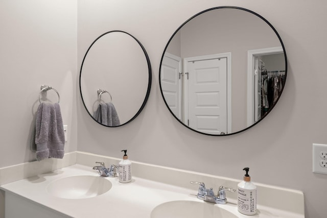 full bathroom with a sink and double vanity