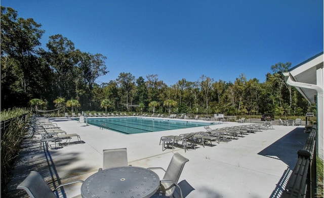 pool featuring a patio area and fence