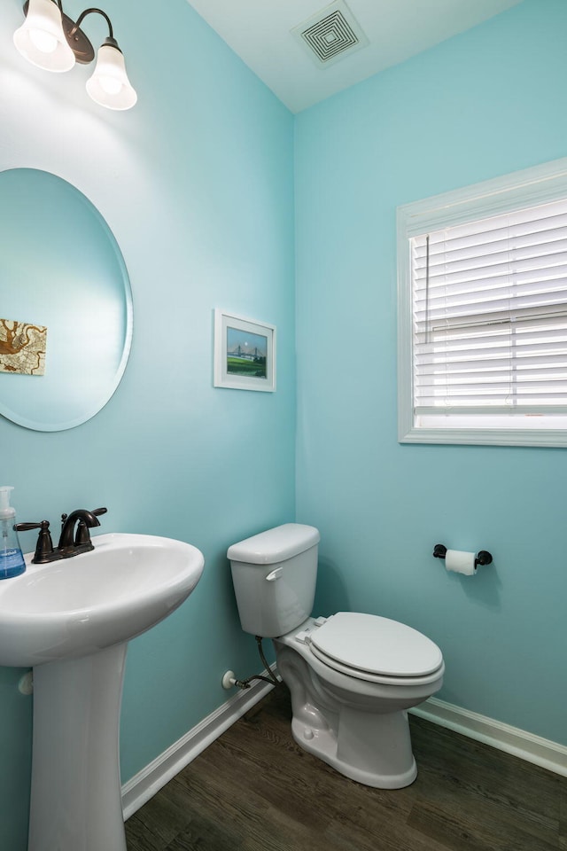 8402 Loggers Run, North Charleston, SC 29420 - half bath with toilet, wood finished floors, baseboards, and a sink