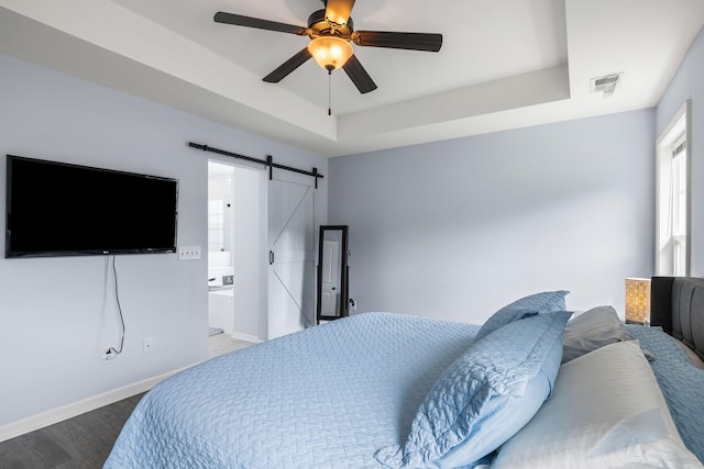 8402 Loggers Run, North Charleston, SC 29420 - bedroom with a barn door, wood finished floors, a raised ceiling, baseboards, and ceiling fan