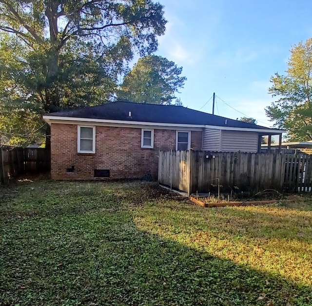 rear view of property with a yard