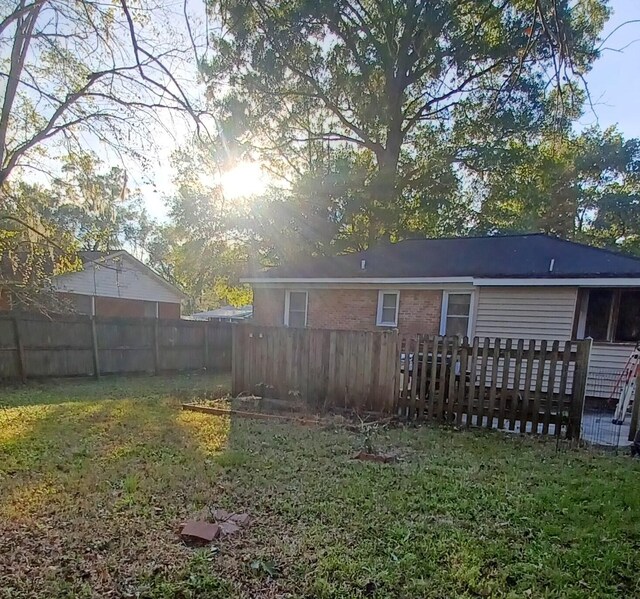 back of property featuring a yard