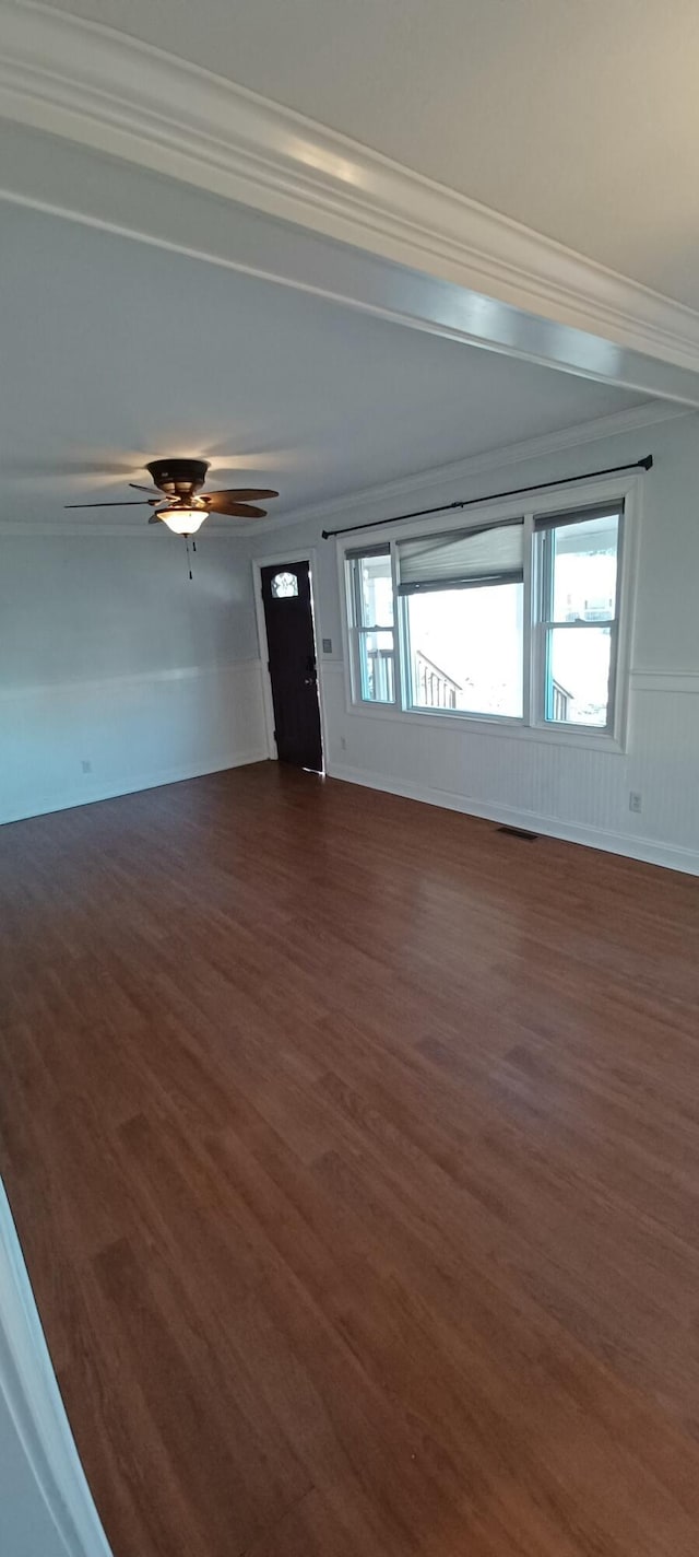 unfurnished room with dark hardwood / wood-style flooring, ceiling fan, and ornamental molding