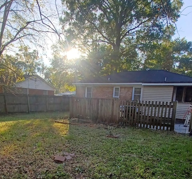 rear view of property featuring a lawn