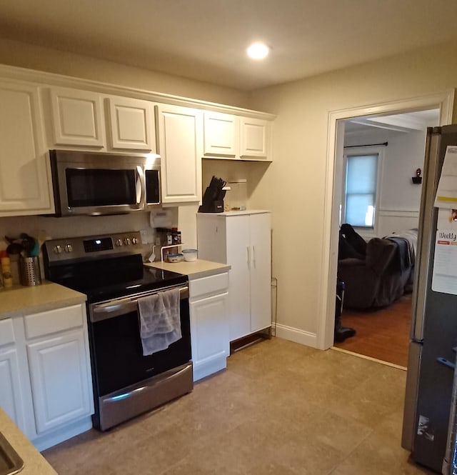 kitchen with white cabinets and appliances with stainless steel finishes