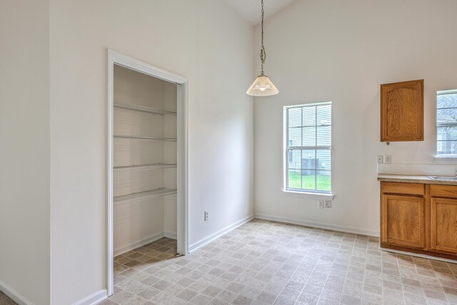206 Barnwell St, Summerville, SC 29483 - unfurnished dining area featuring baseboards, high vaulted ceiling, light floors, and a sink