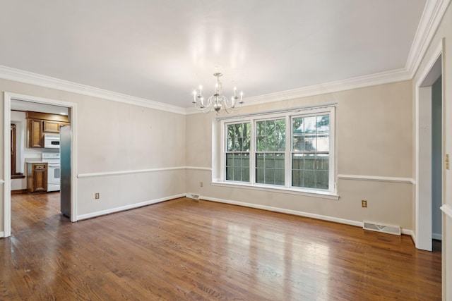 spare room with a notable chandelier, dark hardwood / wood-style flooring, and crown molding