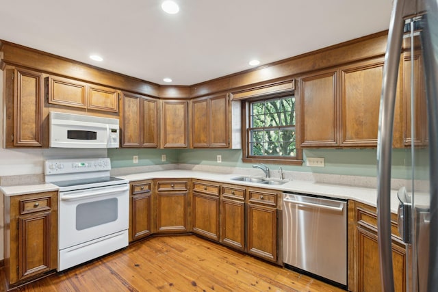 kitchen with sink, light hardwood / wood-style flooring, and appliances with stainless steel finishes