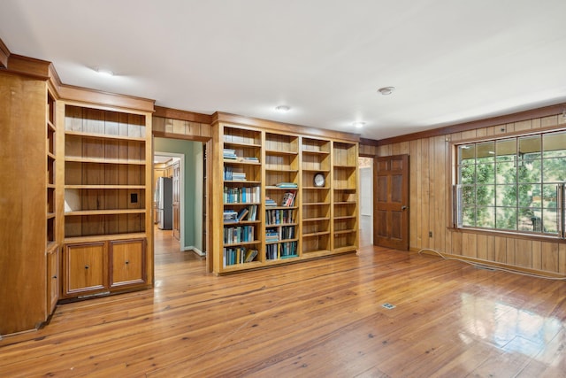 interior space featuring wooden walls and light hardwood / wood-style floors