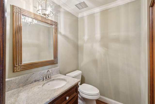 bathroom with vanity, toilet, crown molding, and a chandelier