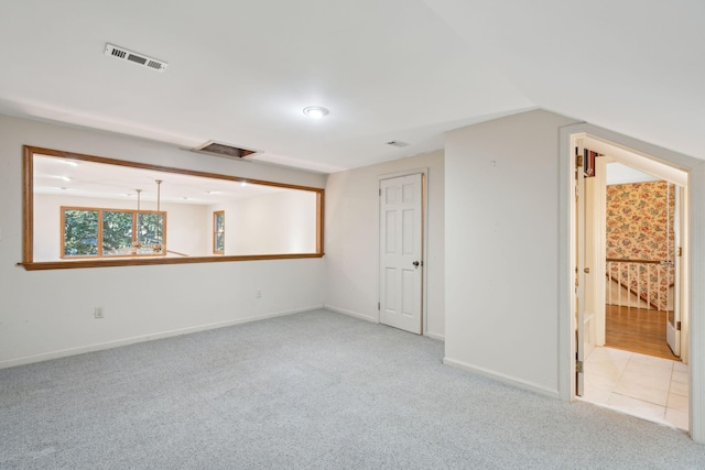 carpeted empty room with lofted ceiling