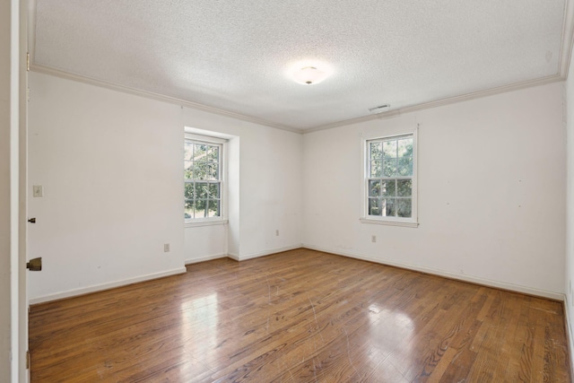 unfurnished room with wood-type flooring, a textured ceiling, and crown molding