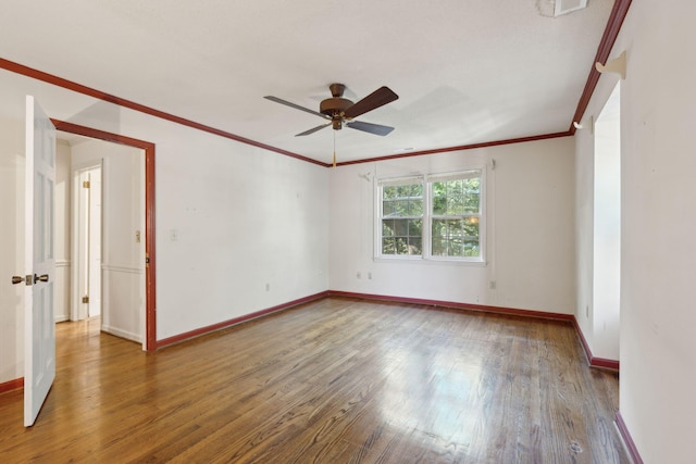 empty room featuring wood-type flooring, ceiling fan, and ornamental molding