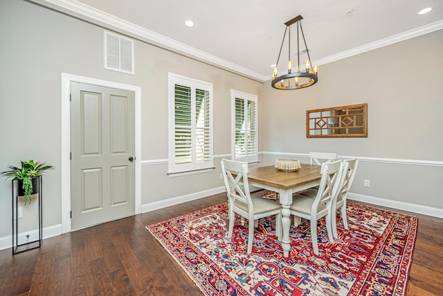 dining space with baseboards, a chandelier, crown molding, visible vents, and wood finished floors