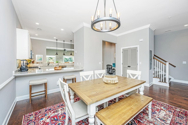 dining space with dark wood-type flooring, an inviting chandelier, and ornamental molding
