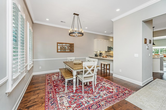 dining area featuring dark wood-type flooring, visible vents, and ornamental molding