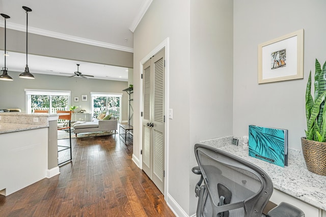 corridor featuring dark wood-type flooring, baseboards, and ornamental molding