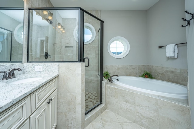 full bathroom with a bath, a stall shower, vanity, and tile patterned flooring