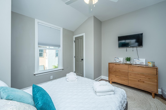 bedroom featuring baseboards, a ceiling fan, and vaulted ceiling
