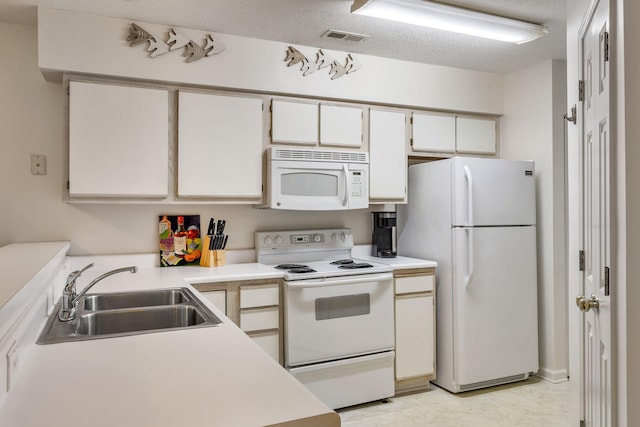 kitchen featuring white appliances, a textured ceiling, sink, and white cabinets