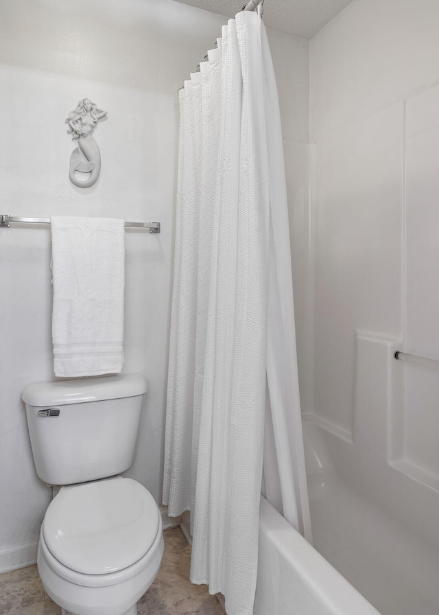 bathroom with toilet and shower / tub combo