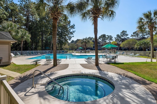 view of swimming pool featuring a patio and a community hot tub