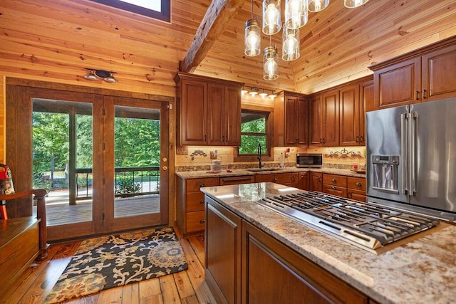 kitchen featuring light stone countertops, stainless steel appliances, wood-type flooring, decorative light fixtures, and wooden ceiling