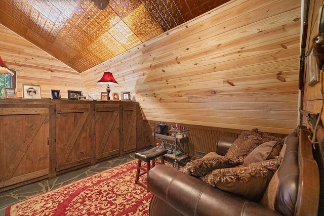 living area with wood walls and lofted ceiling