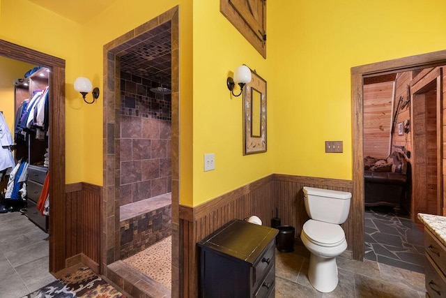 bathroom featuring tiled shower, vanity, and toilet