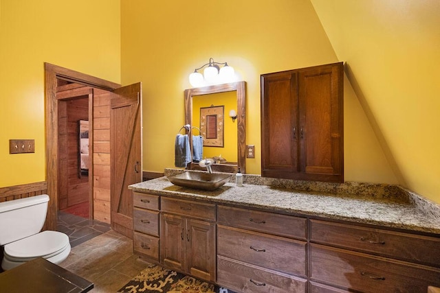 bathroom with tile patterned flooring, vanity, and toilet