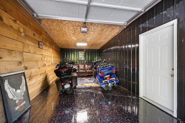 garage featuring wood ceiling, a garage door opener, and wooden walls