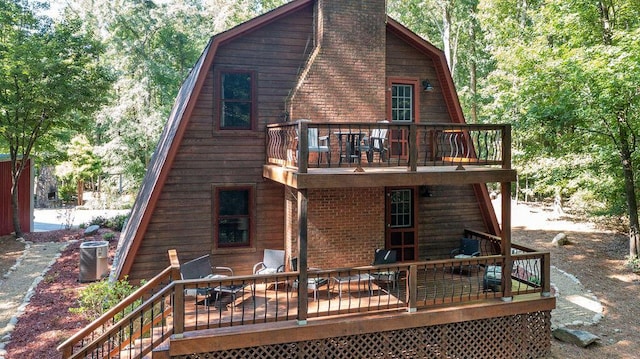 rear view of house featuring central air condition unit and a deck