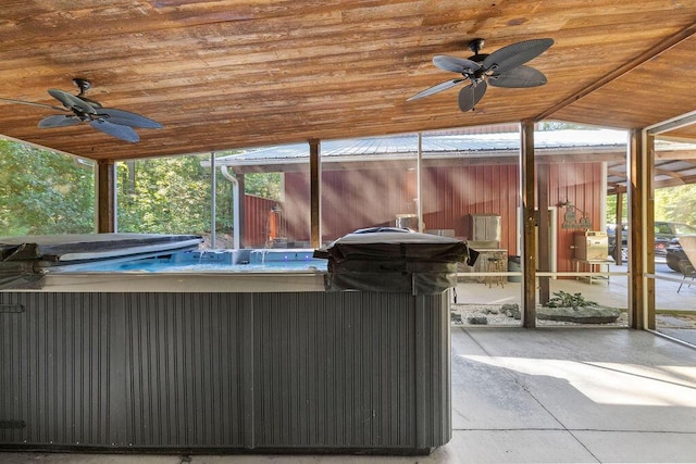 view of patio with ceiling fan and a hot tub