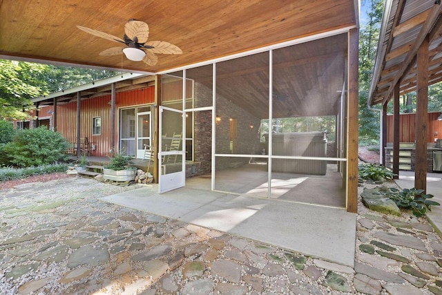 view of patio / terrace featuring a sunroom and ceiling fan