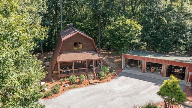 view of front of home with a porch and an outbuilding