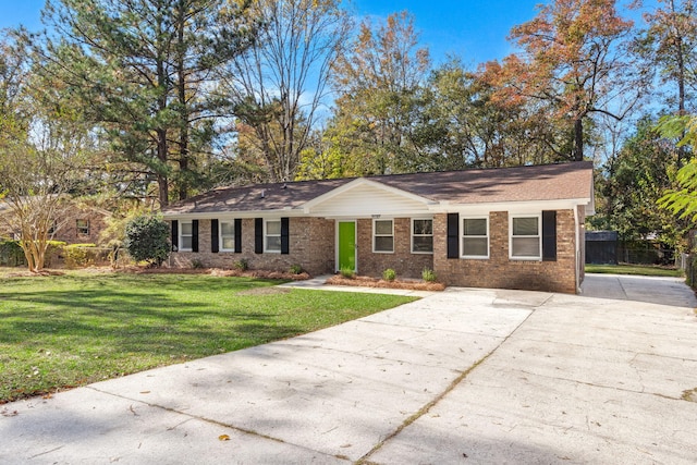 ranch-style house with concrete driveway and brick siding