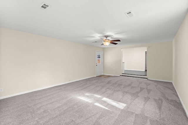 unfurnished room featuring a ceiling fan, carpet floors, and baseboards