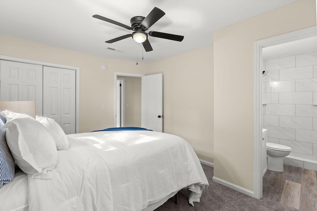 bedroom featuring a closet, baseboards, ensuite bath, and ceiling fan