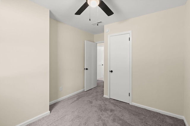 unfurnished bedroom with carpet floors, baseboards, and a ceiling fan