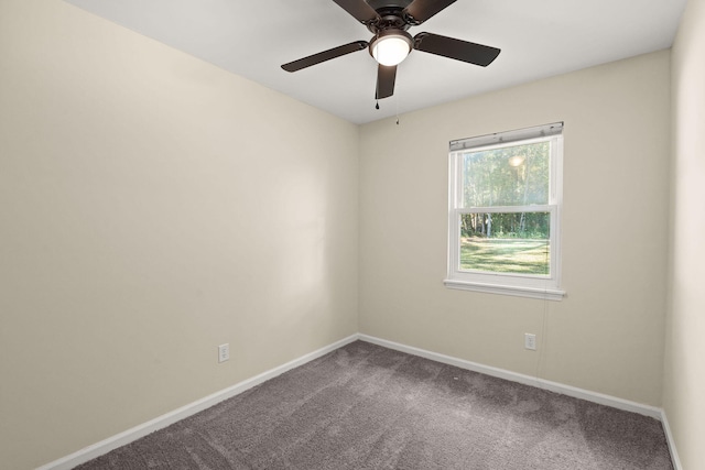 carpeted empty room featuring baseboards and a ceiling fan