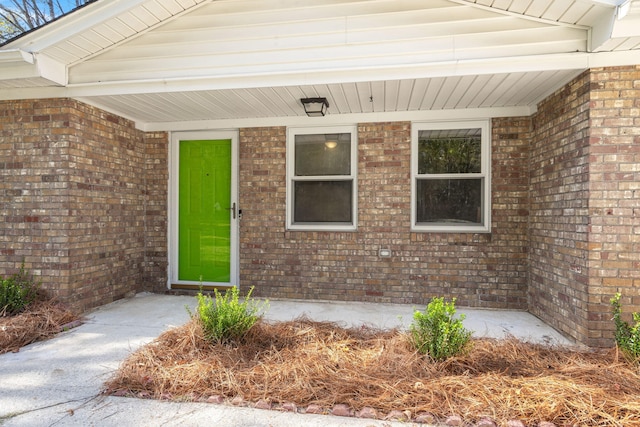 entrance to property with brick siding