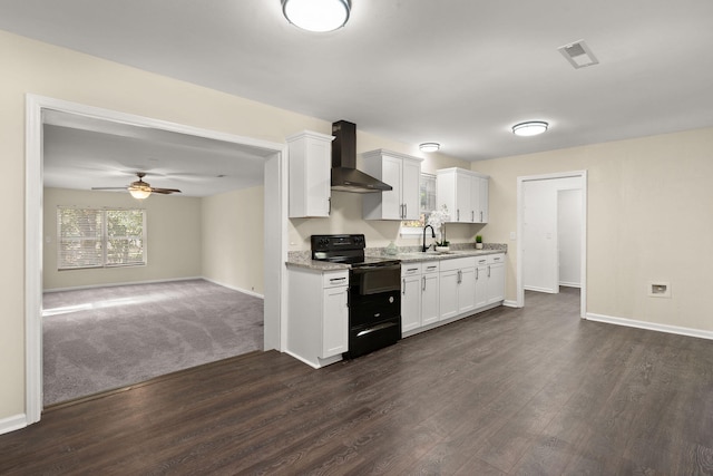kitchen featuring black range with electric stovetop, wall chimney range hood, dark wood-type flooring, and baseboards