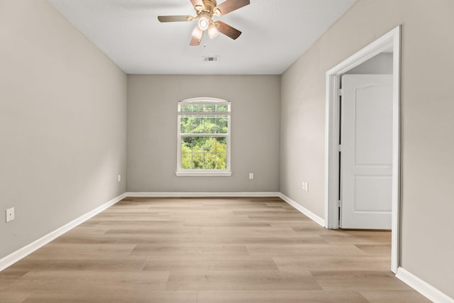 empty room with ceiling fan and light wood-type flooring